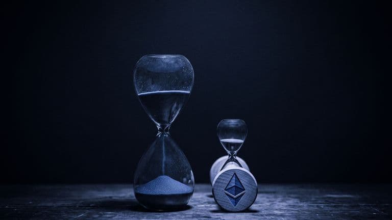 A tall hourglass stands beside a much smaller hourglass marked with the Ethereum logo, sand running through both in a dark blue scene.